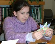Origami proves to be more challenging than originally thought to one young library visitor engaged in a children's workshop supported by the Friends.